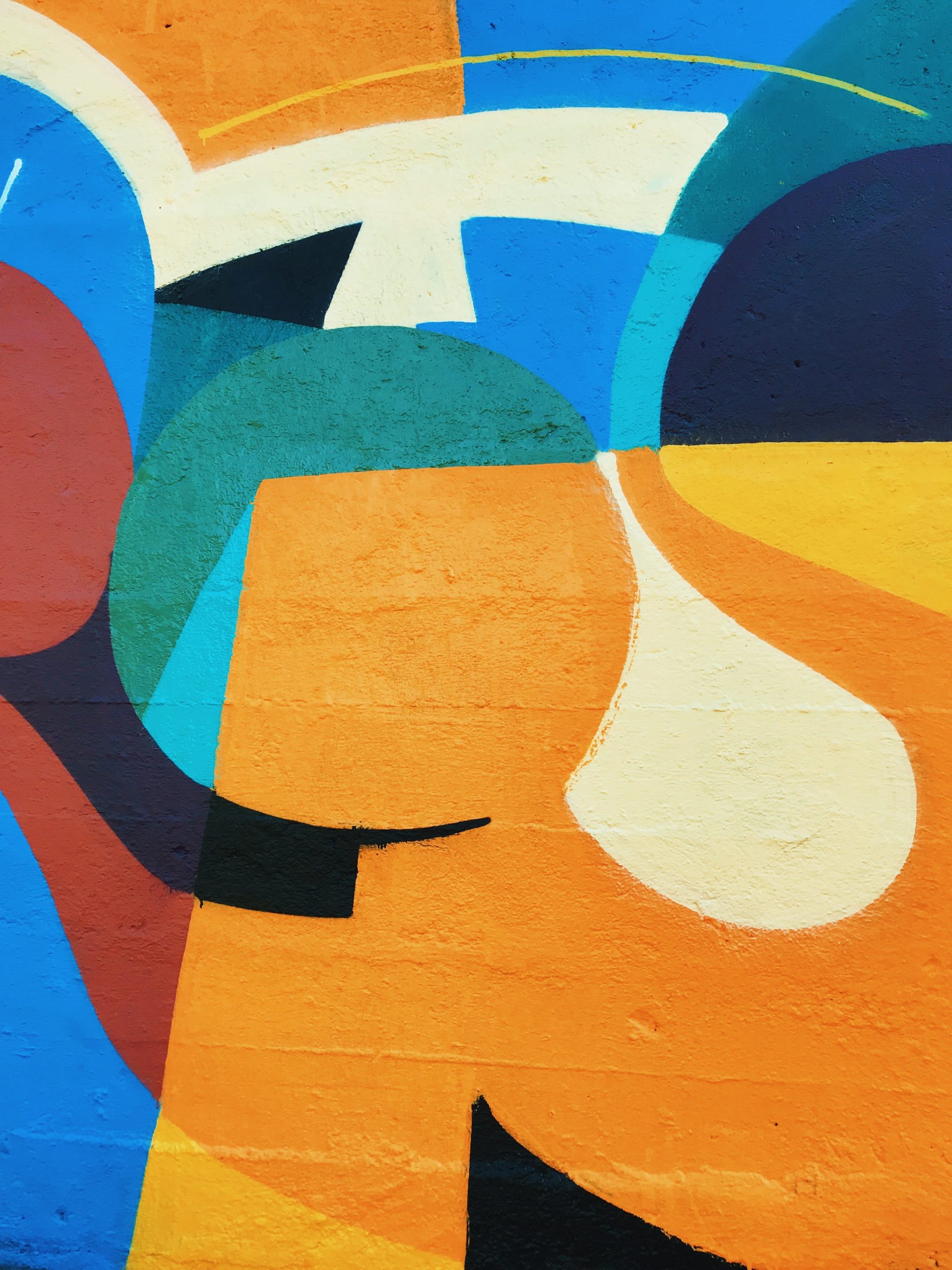 Abstract street art mural with orange and blue colors in Barcelona