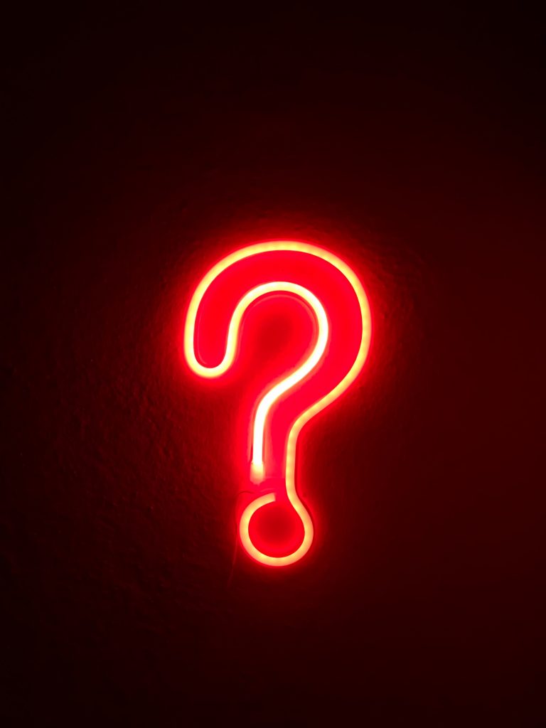 red neon signage question mark